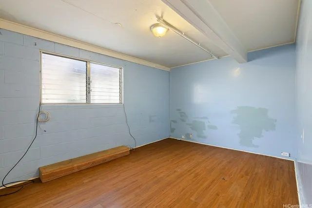 a view of a room with wooden floor and fan
