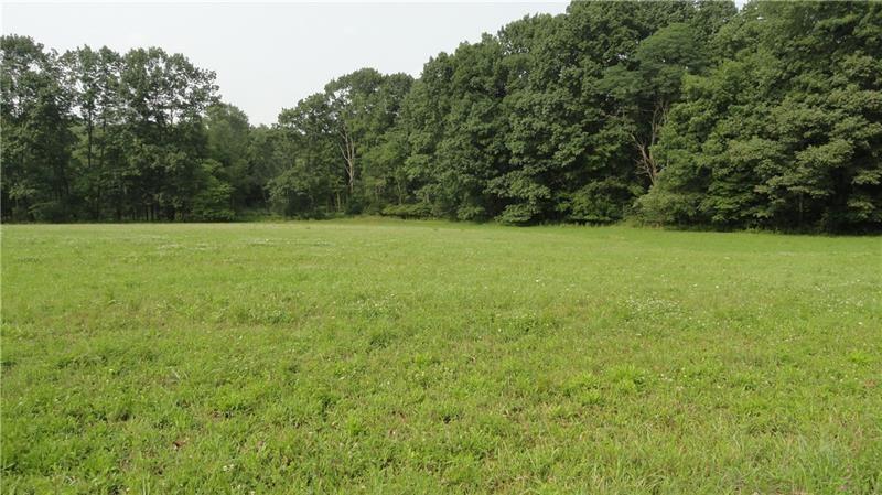a view of field with trees in the background