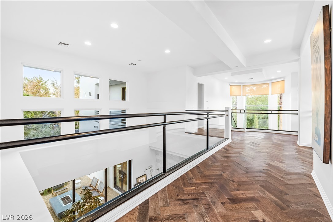 2000 Grouse Street Las Vegas, NV 89134 - Photo 36 of 89 Herringbone hardwood floors extend across this naturally illuminated, multi-level living space with glass railings.