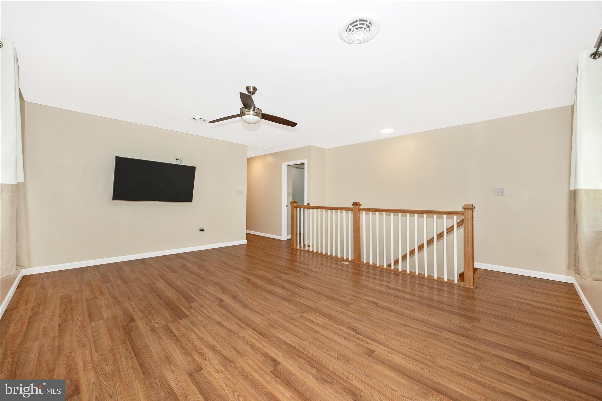6518 Woodville Road Mount Airy, MD 21771 - Photo 23 of 53 a view of a room with wooden floor and windows