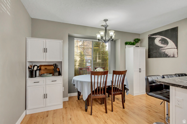 933 South Freedom Boulevard, Unit 7 Provo, UT 84601 - Photo 10 of 23 Dining room with light wood-style flooring and suspended lighting