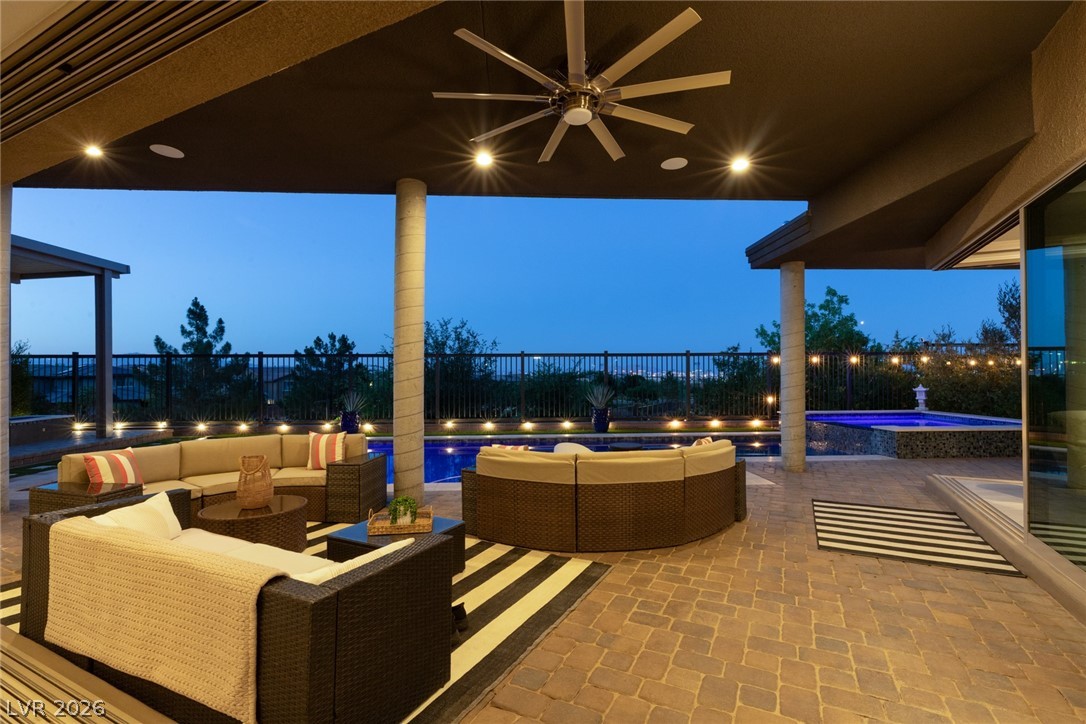 6014 Willow Ridge Court Las Vegas, NV 89135 - Photo 91 of 99 This captivating outdoor living area offers serene evening relaxation and entertainment by the pool.