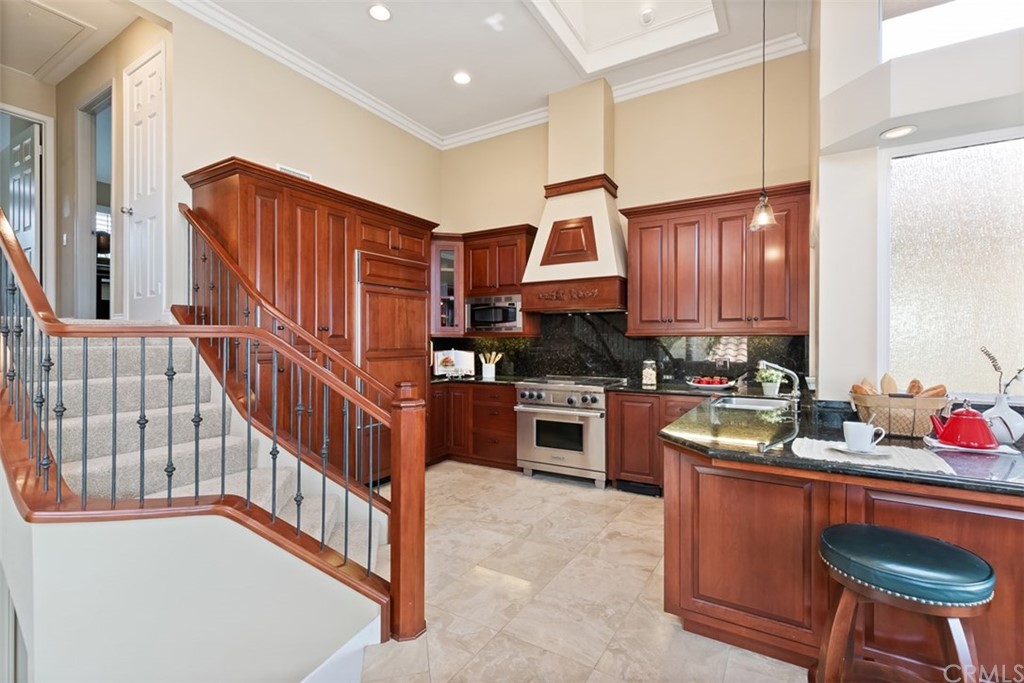 17 St Francis Court Dana Point, CA 92629 - Photo 11 of 66 a kitchen with stainless steel appliances granite countertop a sink a stove a refrigerator cabinets and wooden floor