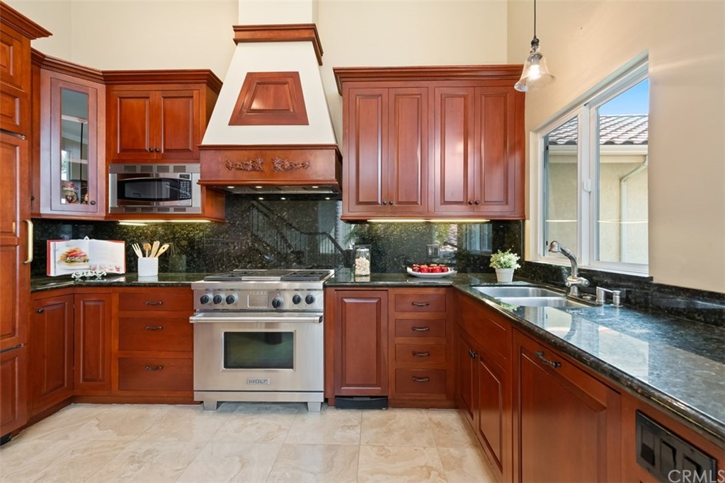 17 St Francis Court Dana Point, CA 92629 - Photo 12 of 66 a kitchen with stainless steel appliances granite countertop a stove a sink and a microwave