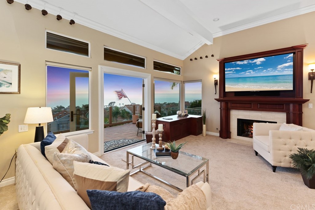 17 St Francis Court Dana Point, CA 92629 - Photo 15 of 66 a living room with furniture a fireplace and a flat screen tv