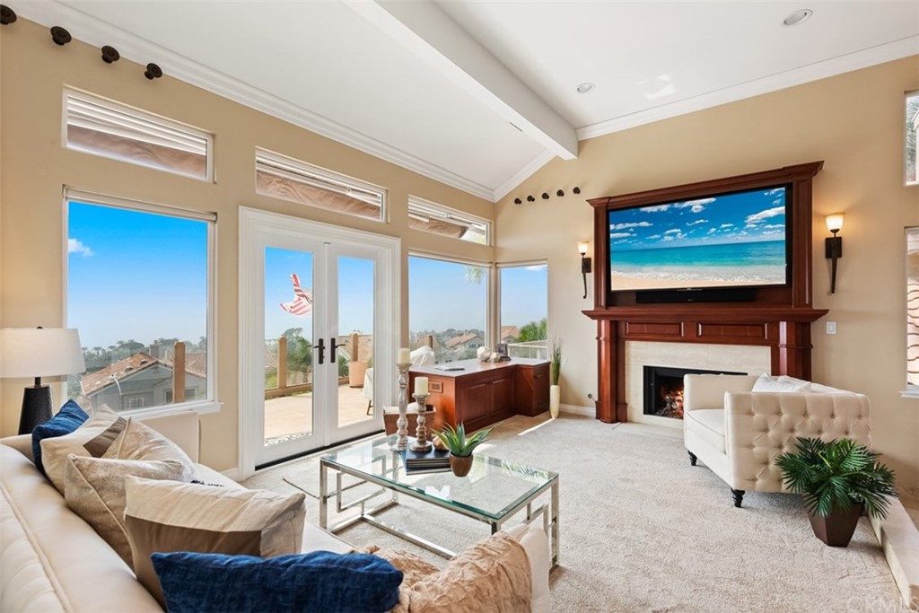 17 St Francis Court Dana Point, CA 92629 - Photo 24 of 66 a living room with furniture a fireplace and a flat screen tv