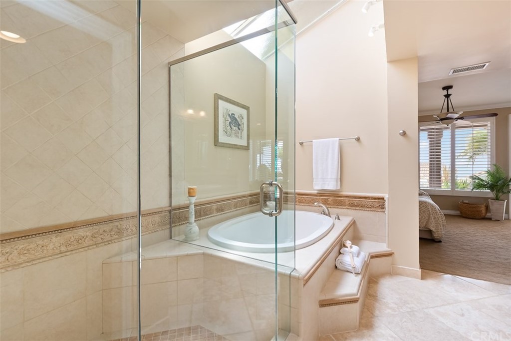 17 St Francis Court Dana Point, CA 92629 - Photo 38 of 66 a bathroom with a sink a mirror and a bathtub