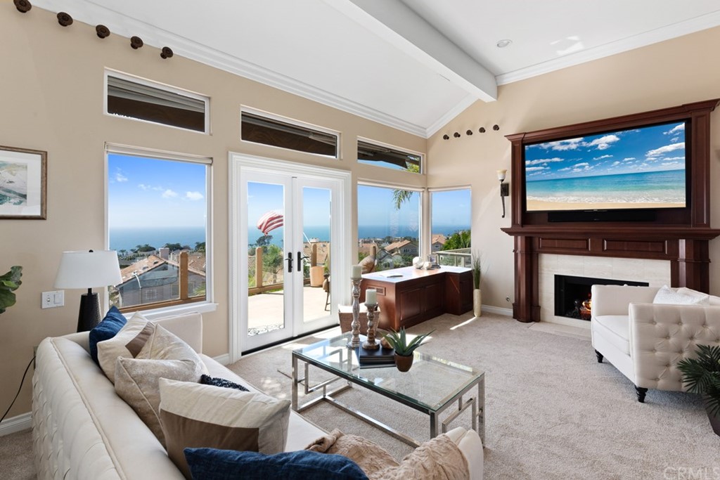 17 St Francis Court Dana Point, CA 92629 - Photo 7 of 66 a living room with furniture a fireplace and a flat screen tv
