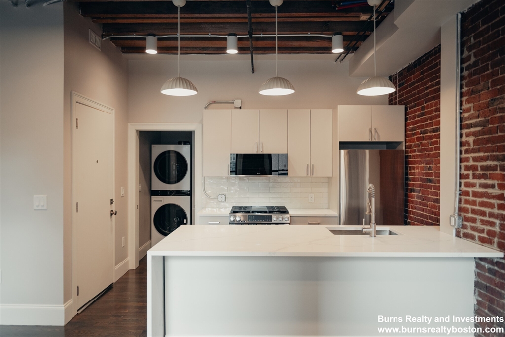 a kitchen with a refrigerator and a sink