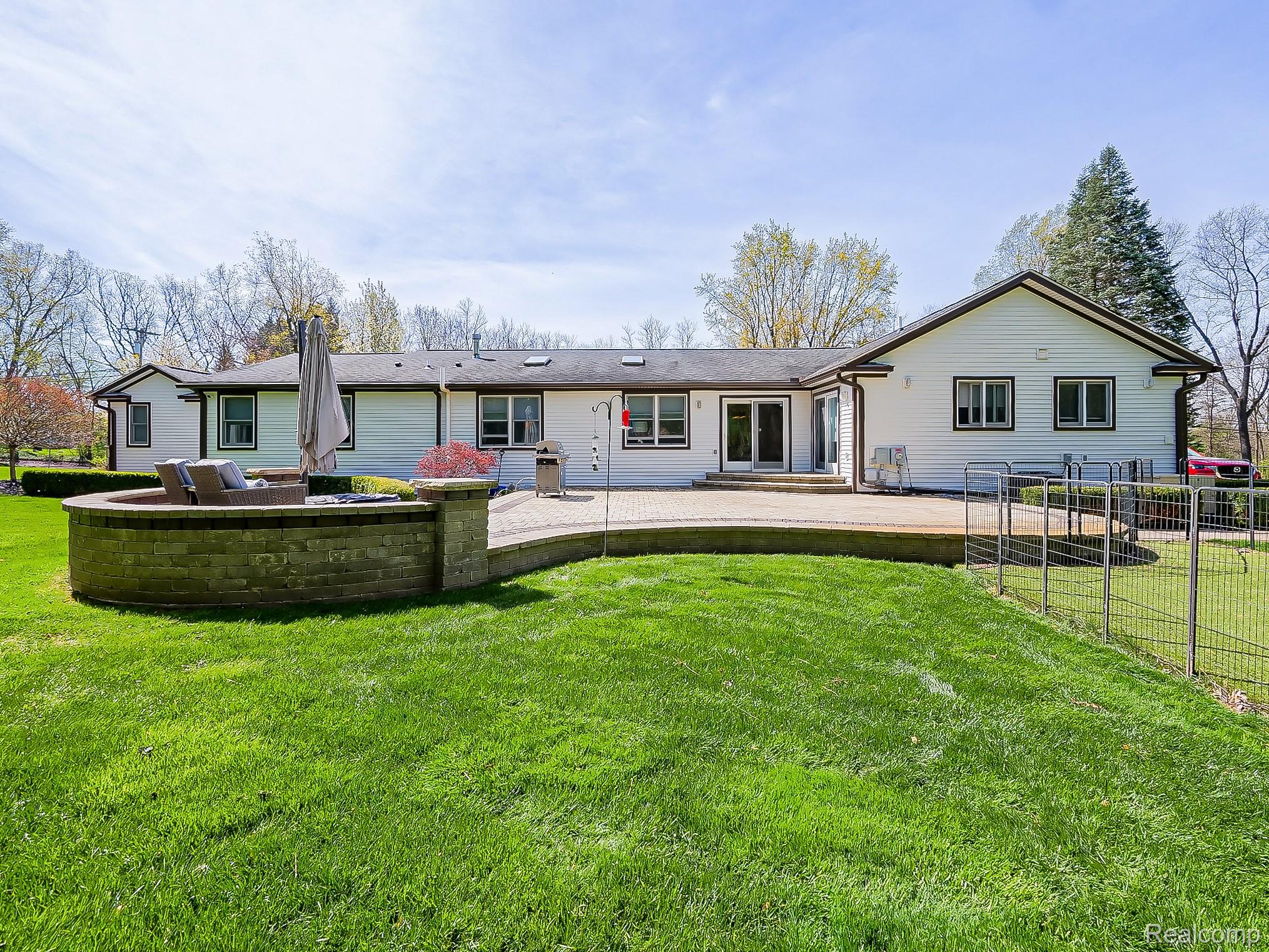 3720 East Clarkston Road Oakland, MI 48363 - Photo 43 of 60 Back of property featuring a lawn