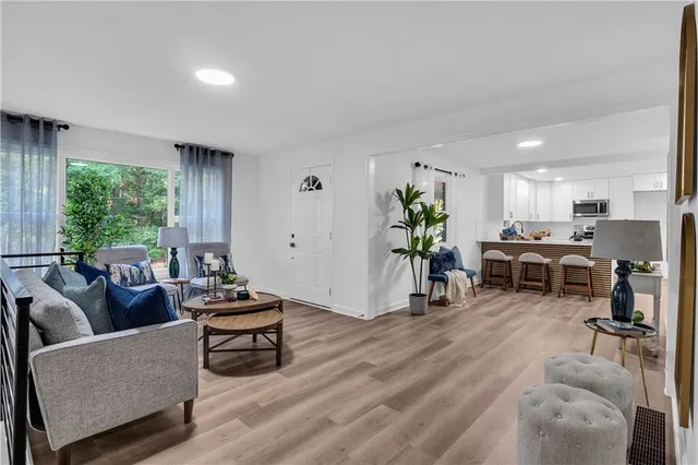 a living room with furniture and a wooden floor