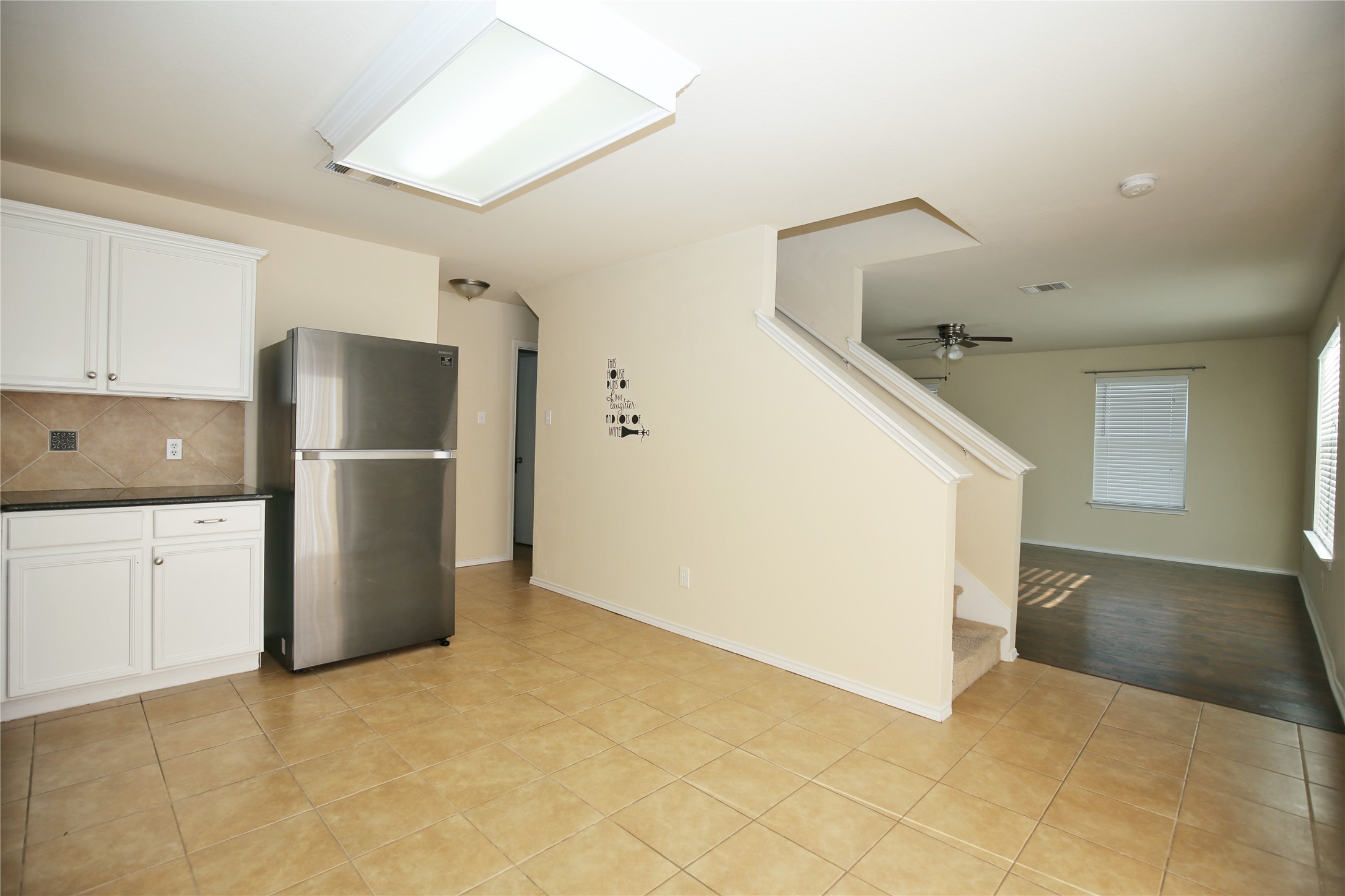 213 Rim Rock Drive Leander, TX 78641 - Photo 8 of 21 a refrigerator freezer sitting in a kitchen with white cabinets