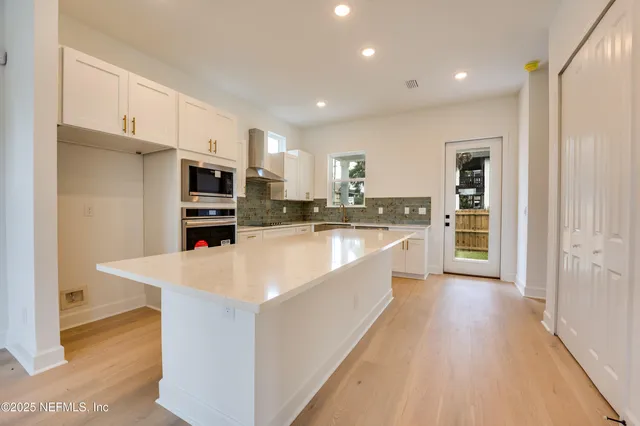 a kitchen with stainless steel appliances a stove a microwave and a refrigerator