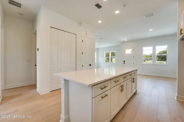 a kitchen with stainless steel appliances kitchen island granite countertop a stove microwave and sink