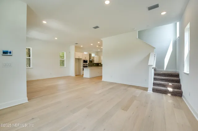 an empty room with windows and closet