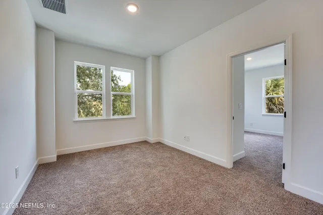 an empty room with closet and a bathroom