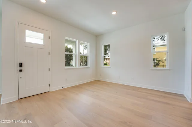 a view of kitchen with kitchen island and stainless steel appliances
