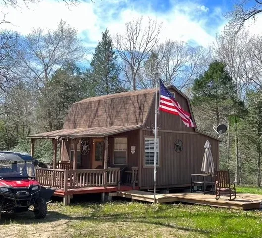 a view of house with a yard