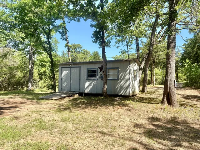a view of a yard with trees