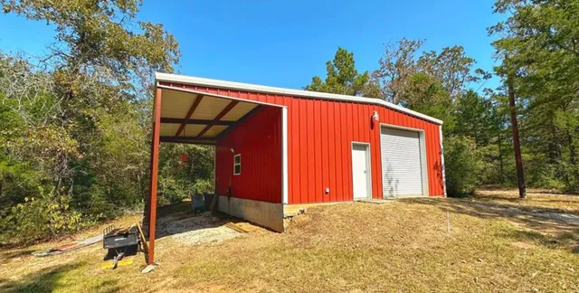a view of a water fountain with large trees
