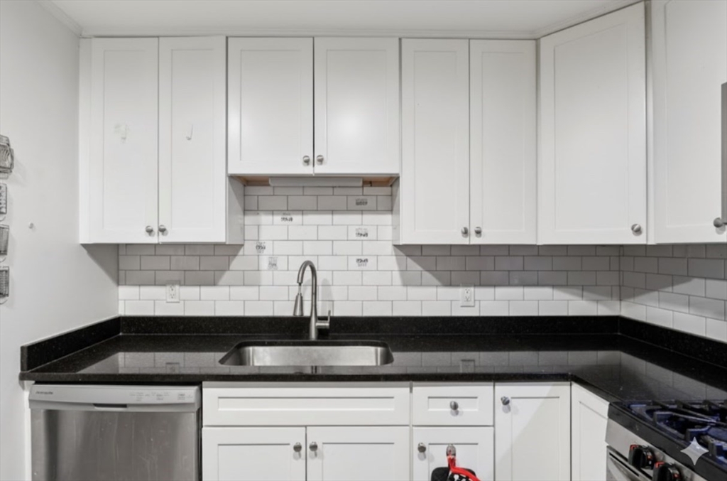 352 Vale Street, Unit 1 Fall River, MA 02724 - Photo 4 of 12 a kitchen with granite countertop white cabinets and a sink