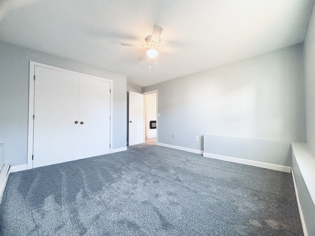 352 Vale Street, Unit 1 Fall River, MA 02724 - Photo 5 of 10 an empty room with an entryway and fan