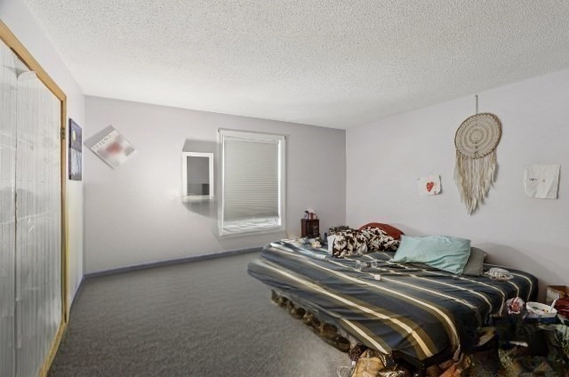 352 Vale Street, Unit 1 Fall River, MA 02724 - Photo 6 of 12 a bedroom with a bed and a chandelier