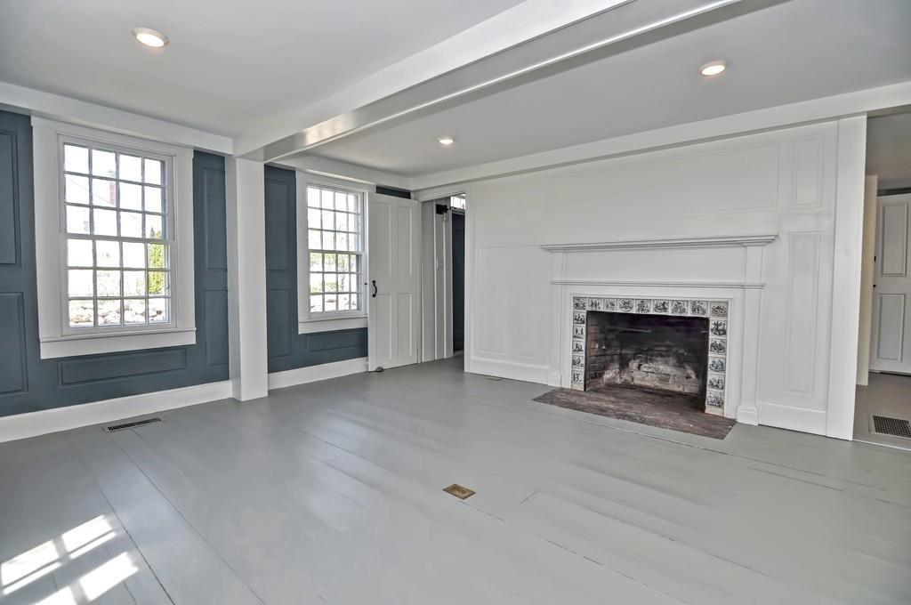 1874 Main Road Westport, MA 02791 - Photo 14 of 28 a view of an empty room with a fireplace and a window