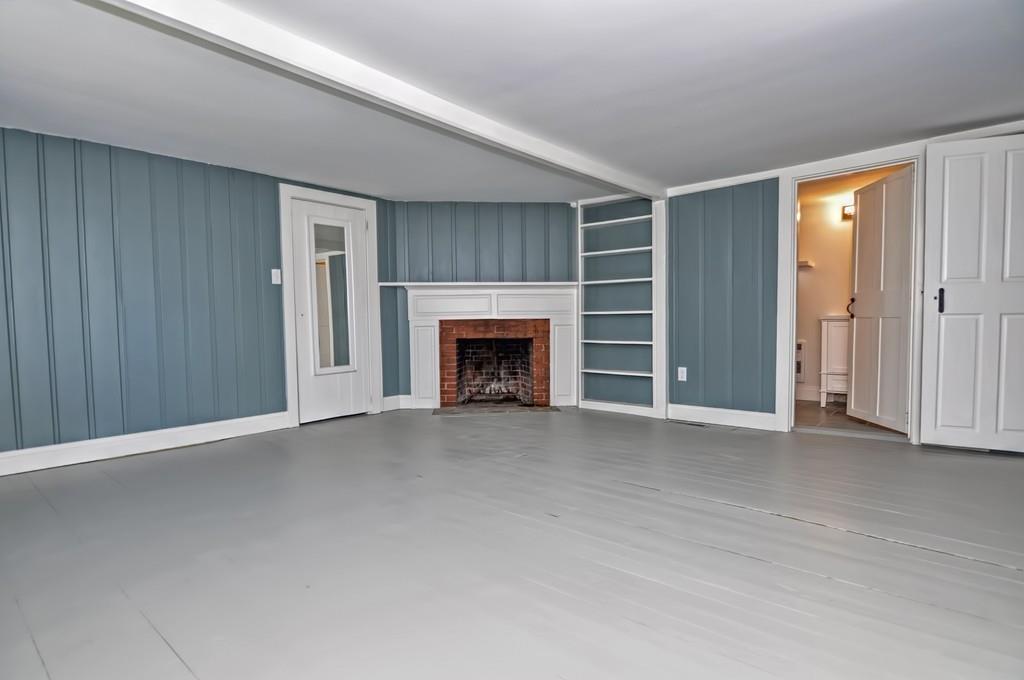 1874 Main Road Westport, MA 02791 - Photo 18 of 28 an empty room with furniture and a fireplace