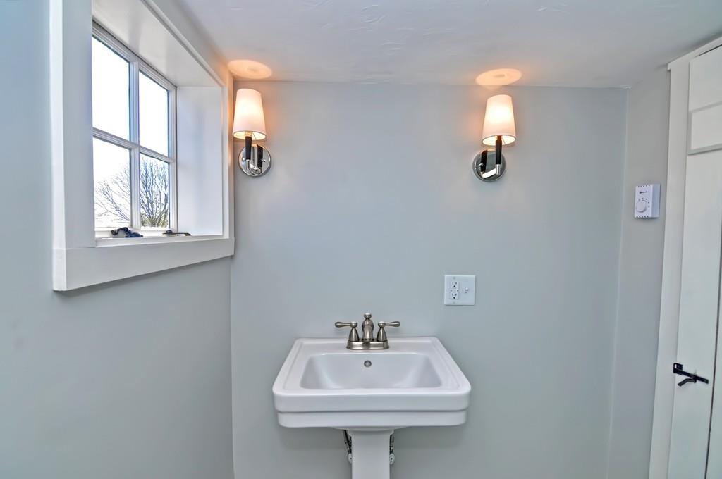 1874 Main Road Westport, MA 02791 - Photo 26 of 28 a bathroom with a sink a mirror and a window