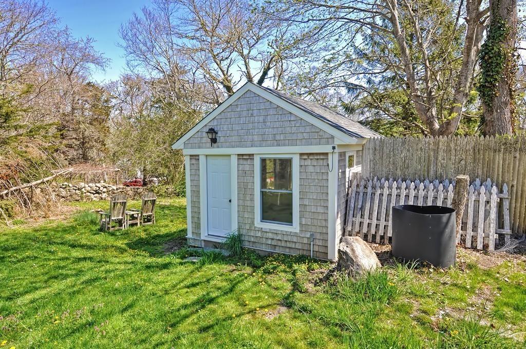 1874 Main Road Westport, MA 02791 - Photo 28 of 28 a backyard of a house with table and chairs