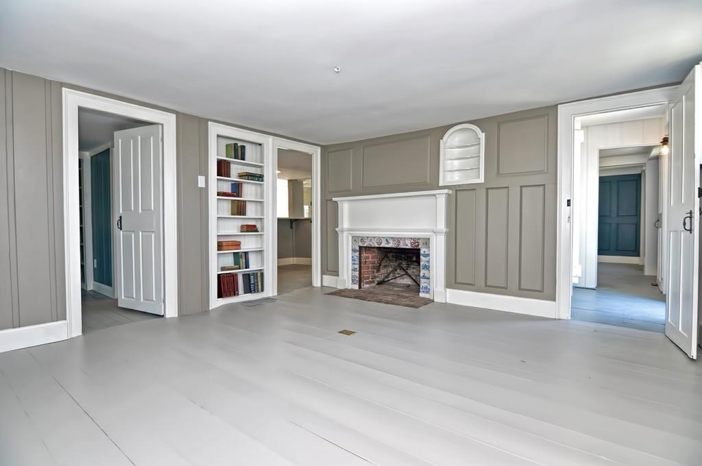 1874 Main Road Westport, MA 02791 - Photo 3 of 28 an empty room with furniture and a fireplace