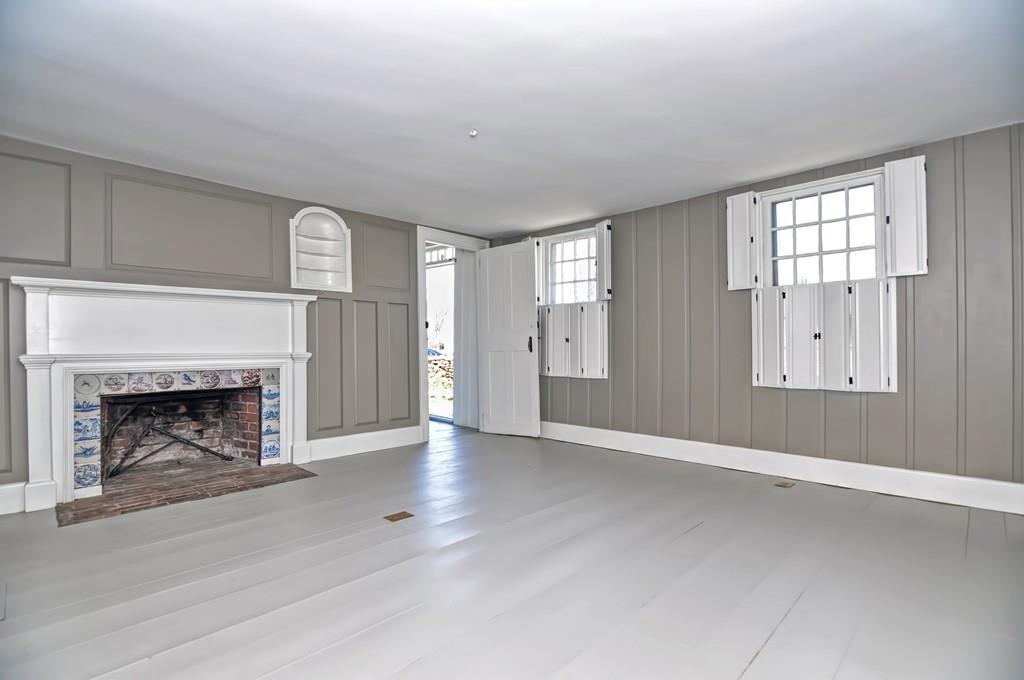 1874 Main Road Westport, MA 02791 - Photo 4 of 28 a view of an empty room with window and fire place