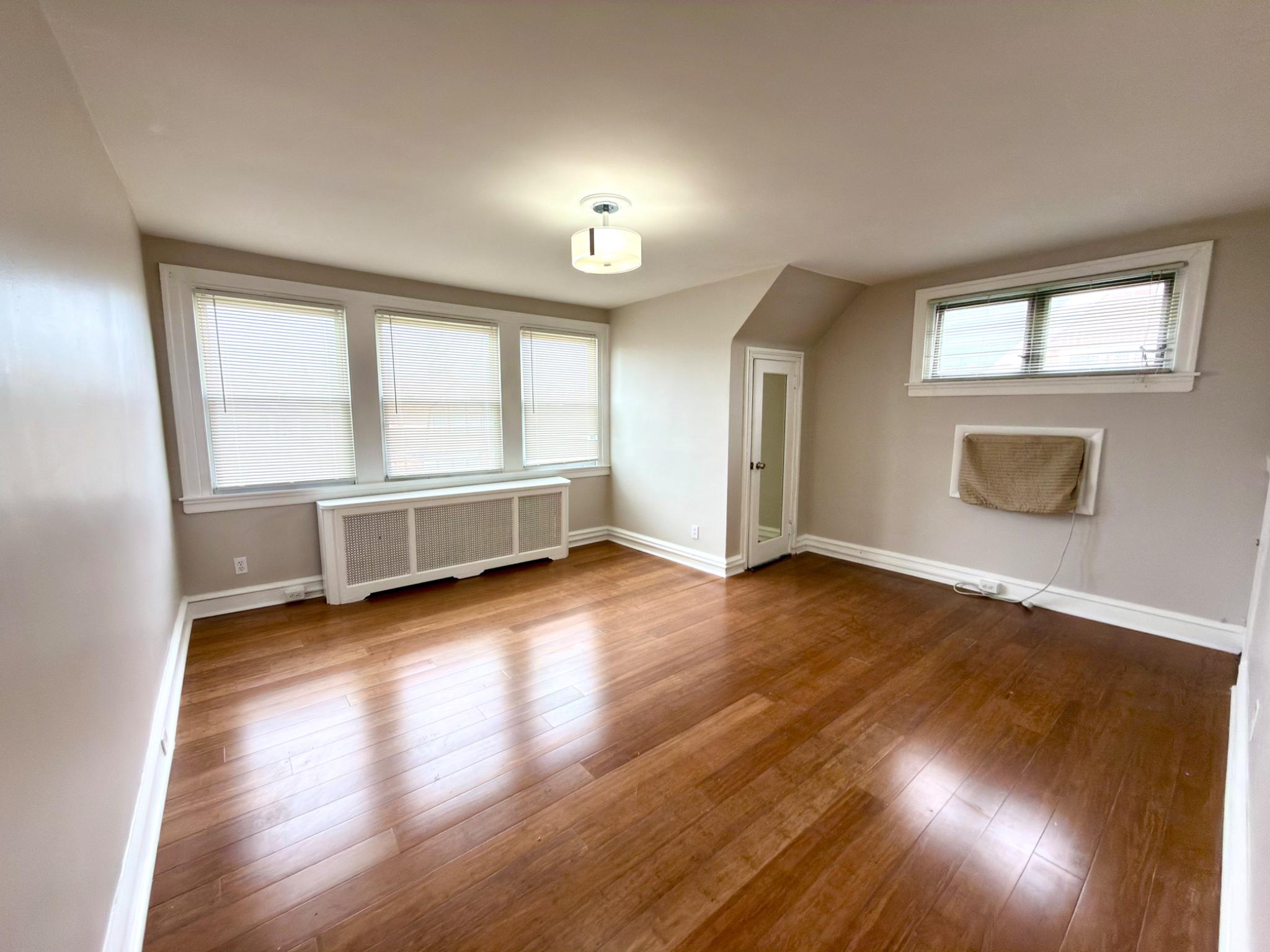 1723 Chelsea Road Elkins Park, PA 19027 - Photo 18 of 38 an empty room with wooden floor and windows