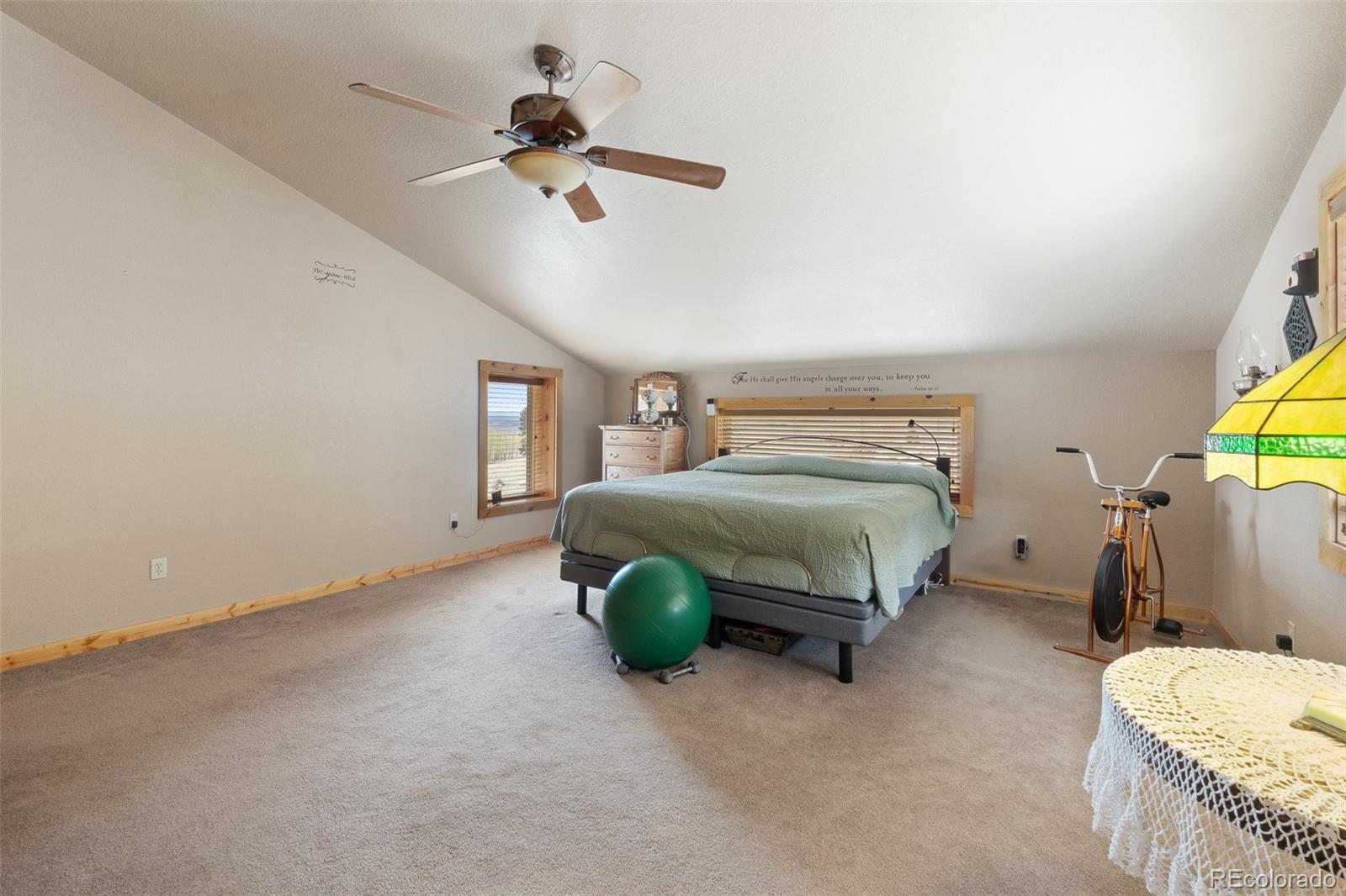 1163 Michigan Hill Road Jefferson, CO 80456 - Photo 27 of 48 a bedroom with a bed window and couch
