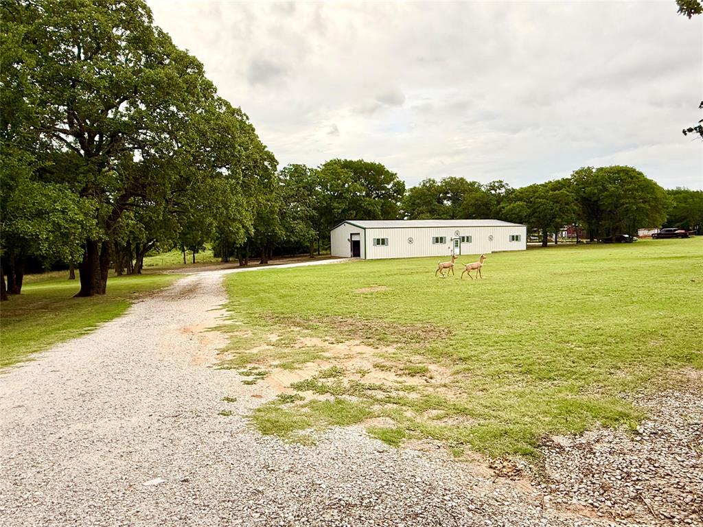 4216 Greenwood Road Weatherford, TX 76088 - Photo 19 of 26 Huge shop with garage doors on 2 sides offers so many possibilities! Wonderful for a business, car collector, a workshop & much more! Has an office area with bath & separate storage area.