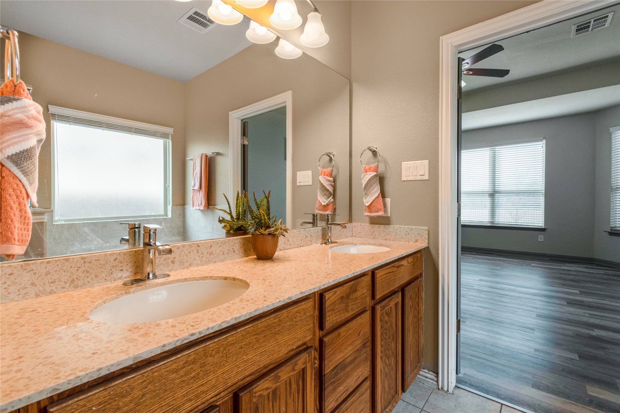 3413 Grail Hollows Road Pflugerville, TX 78660 - Photo 18 of 36 a bathroom with a granite countertop sink and a mirror