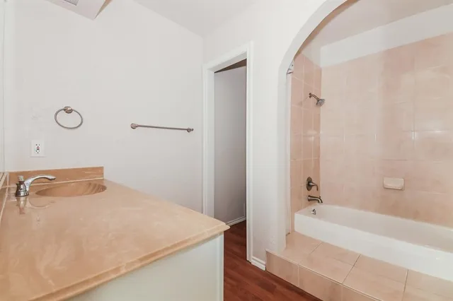 a bathroom with a tub and a sink