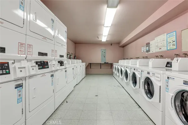 a view of swimming pool with outdoor seating and house in the background