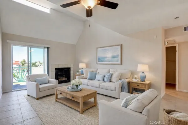 a dining room with furniture and a potted plant