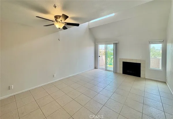 a living room with furniture a fireplace and a large mirror