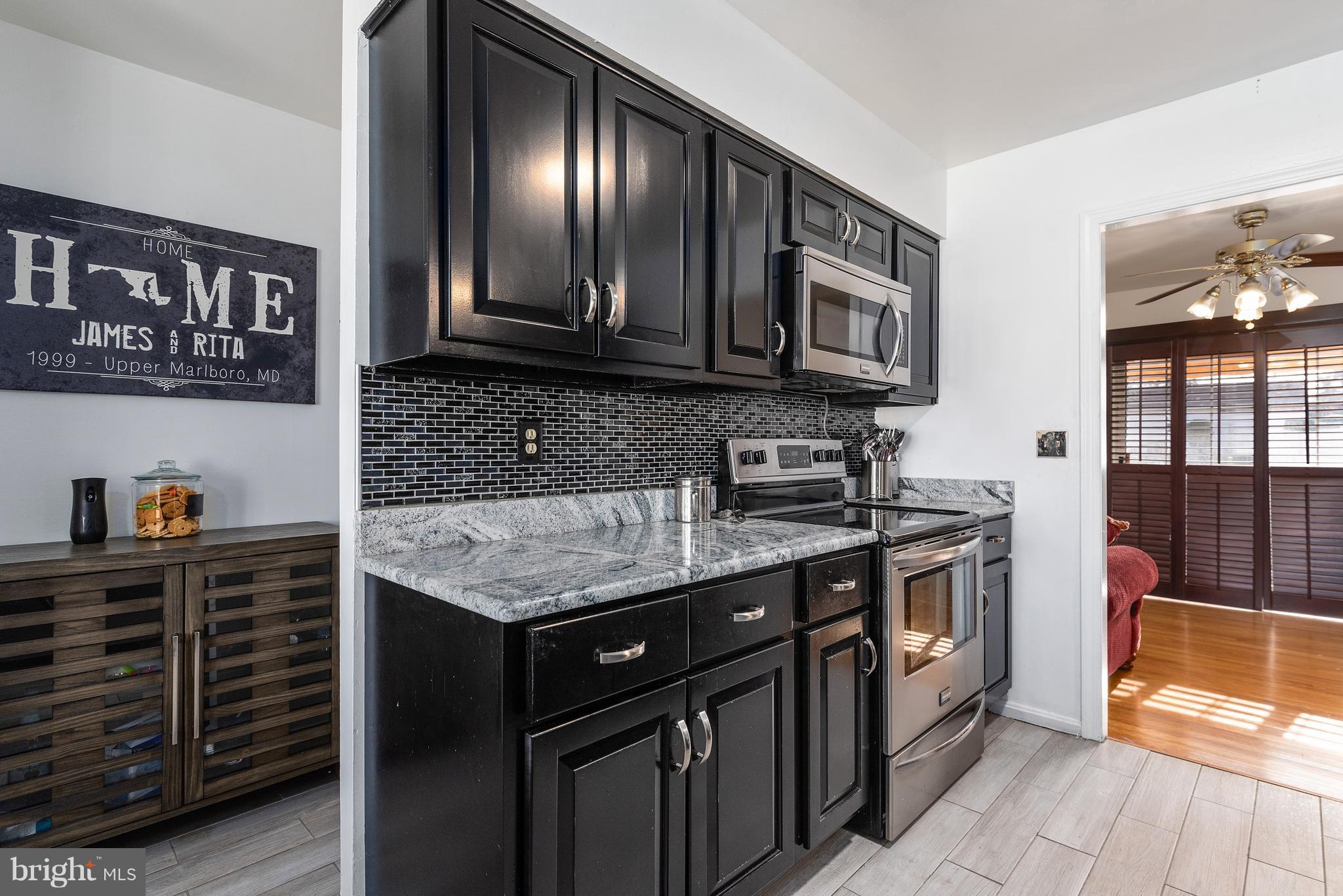 3405 Stonesboro Road Fort Washington, MD 20744 - Photo 8 of 33 a kitchen with stainless steel appliances granite countertop a stove a sink and a microwave