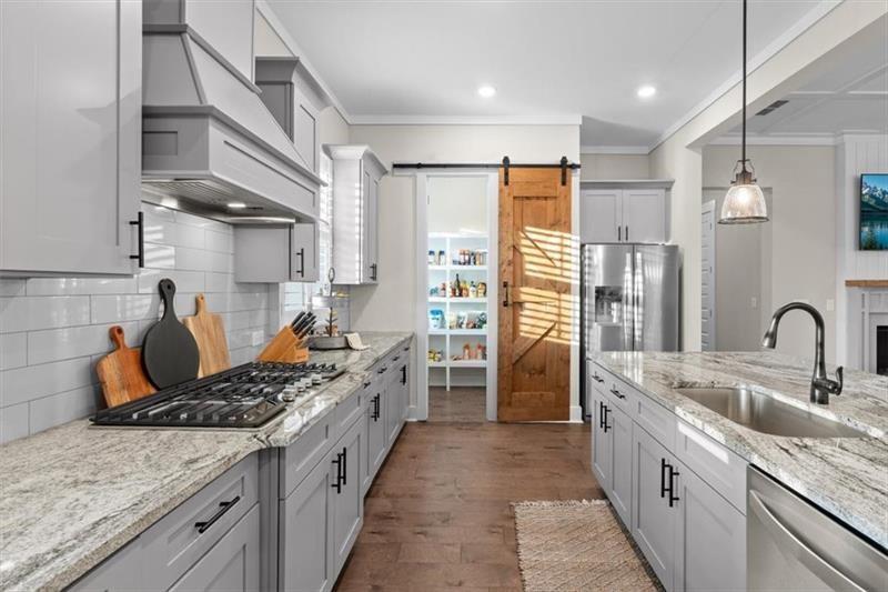 283 London Road Ball Ground, GA 30107 - Photo 25 of 73 a kitchen with stainless steel appliances granite countertop a sink stove and refrigerator