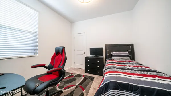 a bedroom with furniture and a window