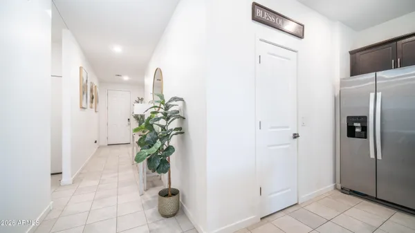 a view of a hallway with closet and a potted plant