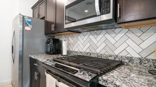 a stove top oven sitting inside of a kitchen