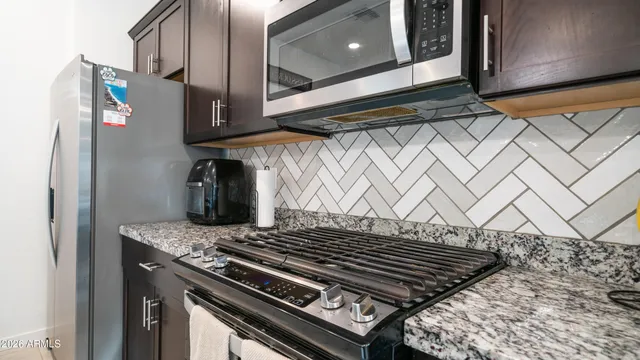 a stove top oven sitting inside of a kitchen