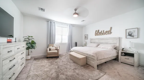 a spacious bedroom with a bed and a couch