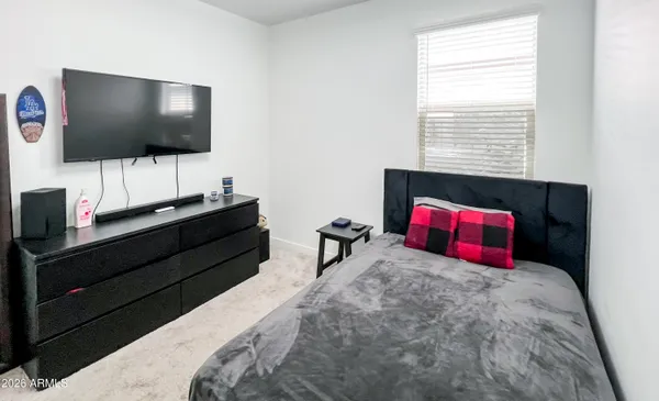 a bedroom with a bed and a flat screen tv
