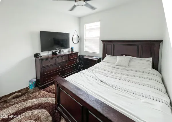 a bedroom with a bed and a flat screen tv